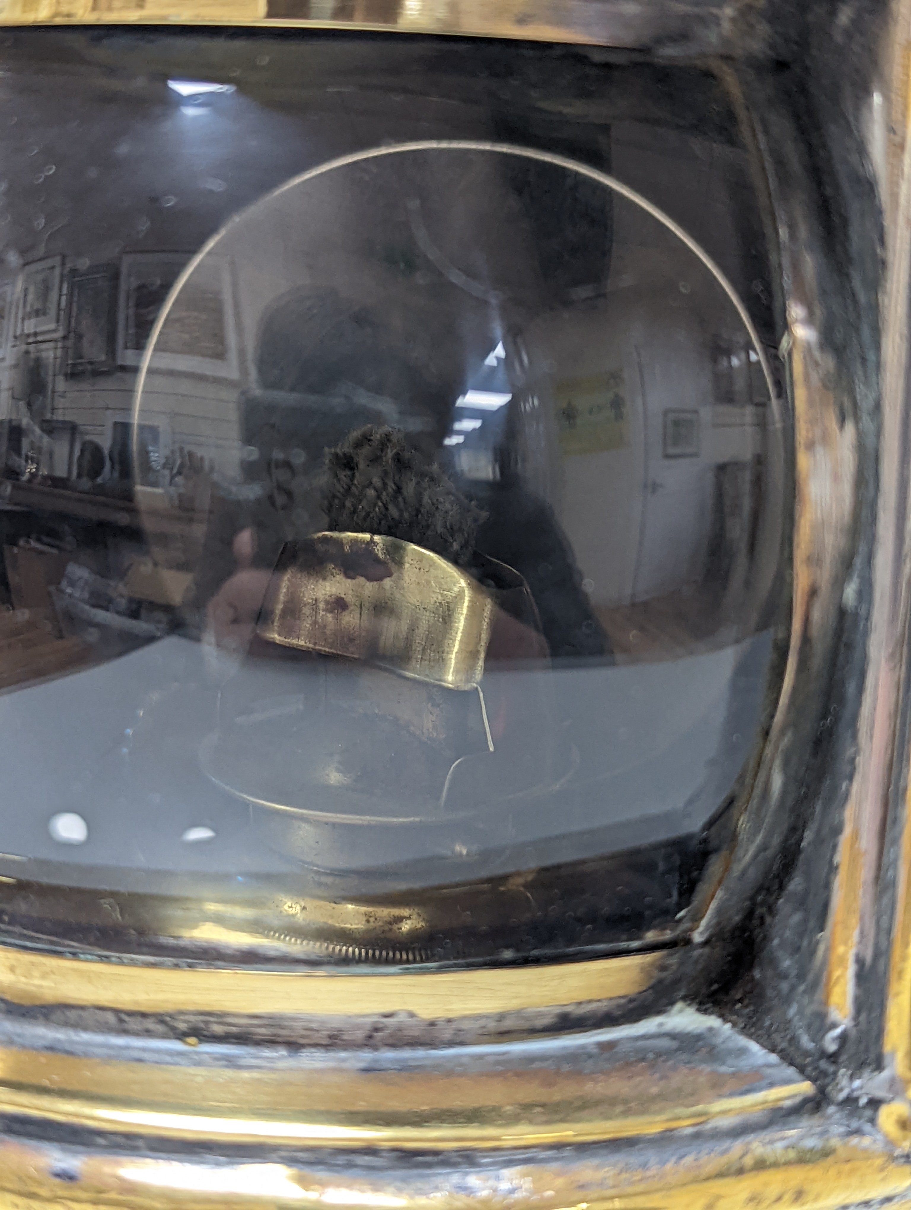 A copper ship's binnacle compass, a brass oil lamp, a brass jug and a copper kettle